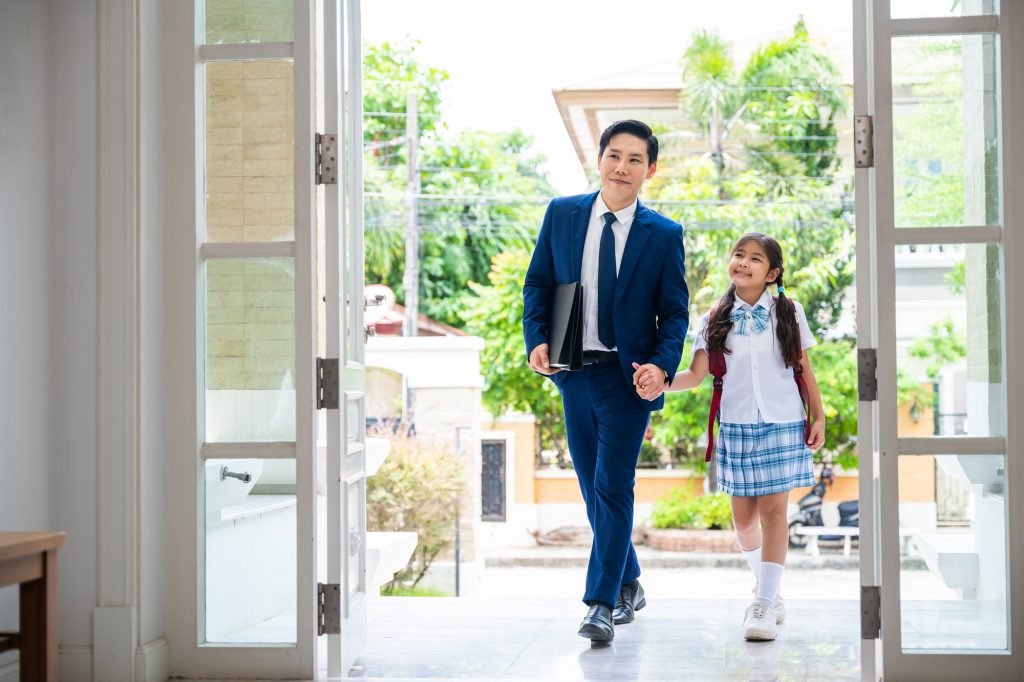 Back to school. Family Asian father and daughter entering main door of home, Father and daughter